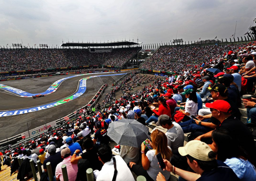 Scene at the Mexican Grand Prix showing a section of the track and spectators in the stands.