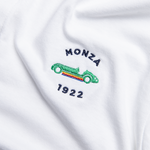 Formula 1 fans: This is a detail shot of a white polo shirt front embroidered with navy Monza name, green vintage Grand Prix car plus navy 1922.