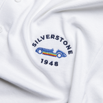 Formula 1 fans: This is a detail shot of a white polo shirt front embroidered with navy Silverstone name, blue vintage Grand Prix car plus navy 1948.